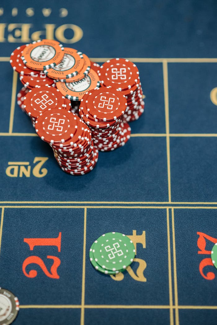 Close-up view of poker chips stacked on a casino gaming table, ready for betting.